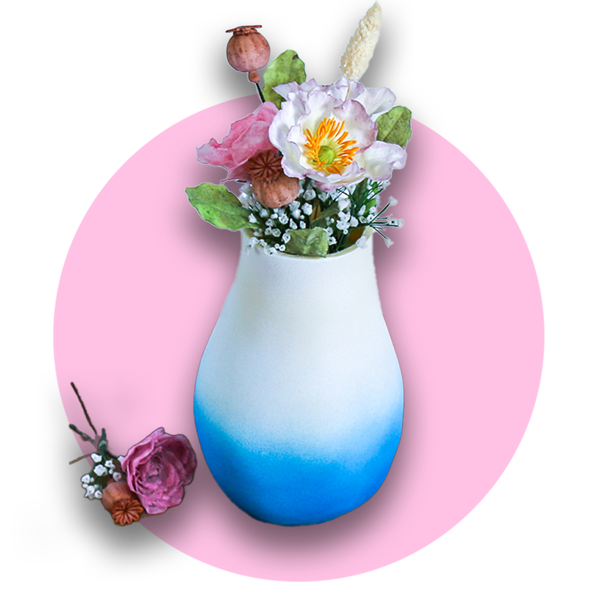 A realistic blue and white vase cake with a bouquet of wafer paper and sugarpaste flowers coming out of the top