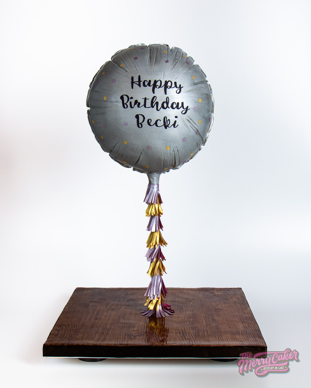 A hyper-realistic gift box present cake with an edible gift bow