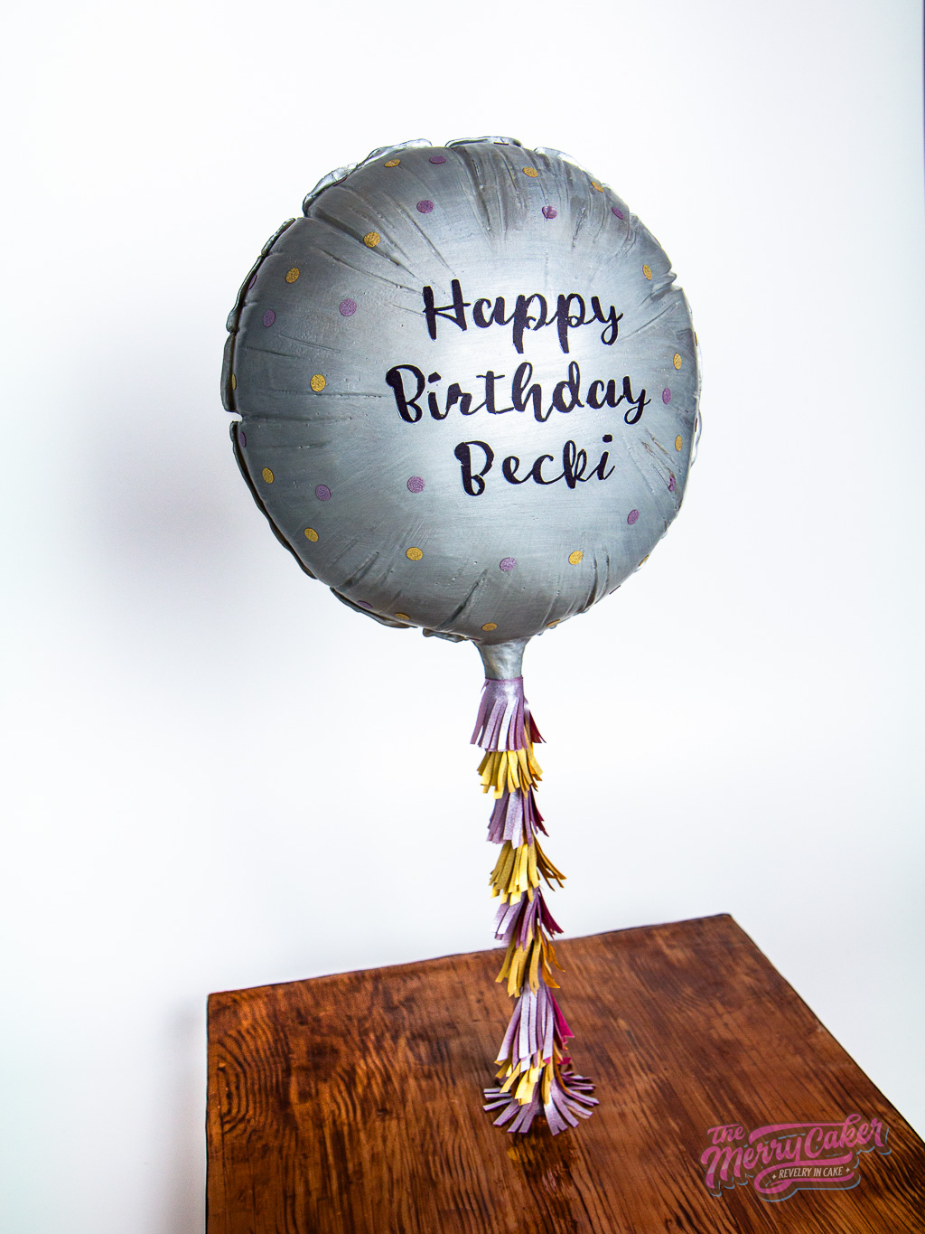 A hyper-realistic gift box present cake with an edible gift bow