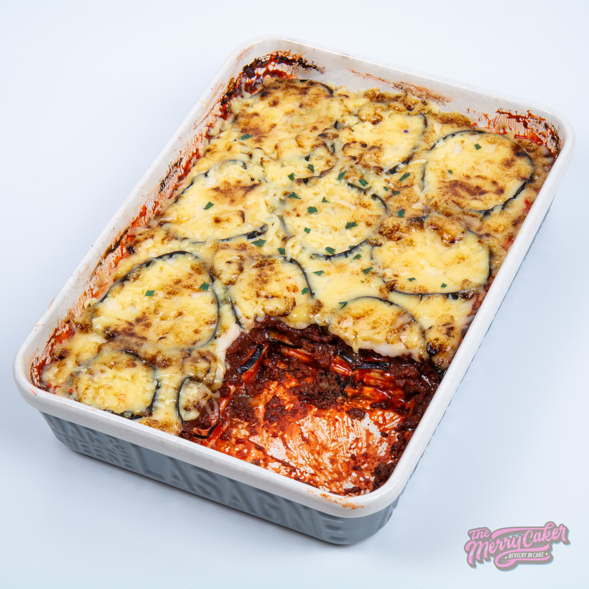 A hyper-realistic moussaka cake decorated with white modelling chocolate. Inside this moussaka was a zesty lemon drizzle cake