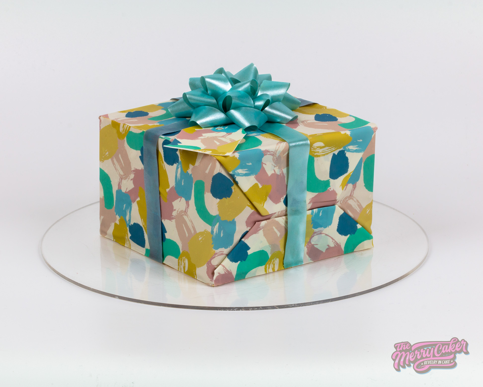 A hyper-realistic gift box present cake with an edible gift bow