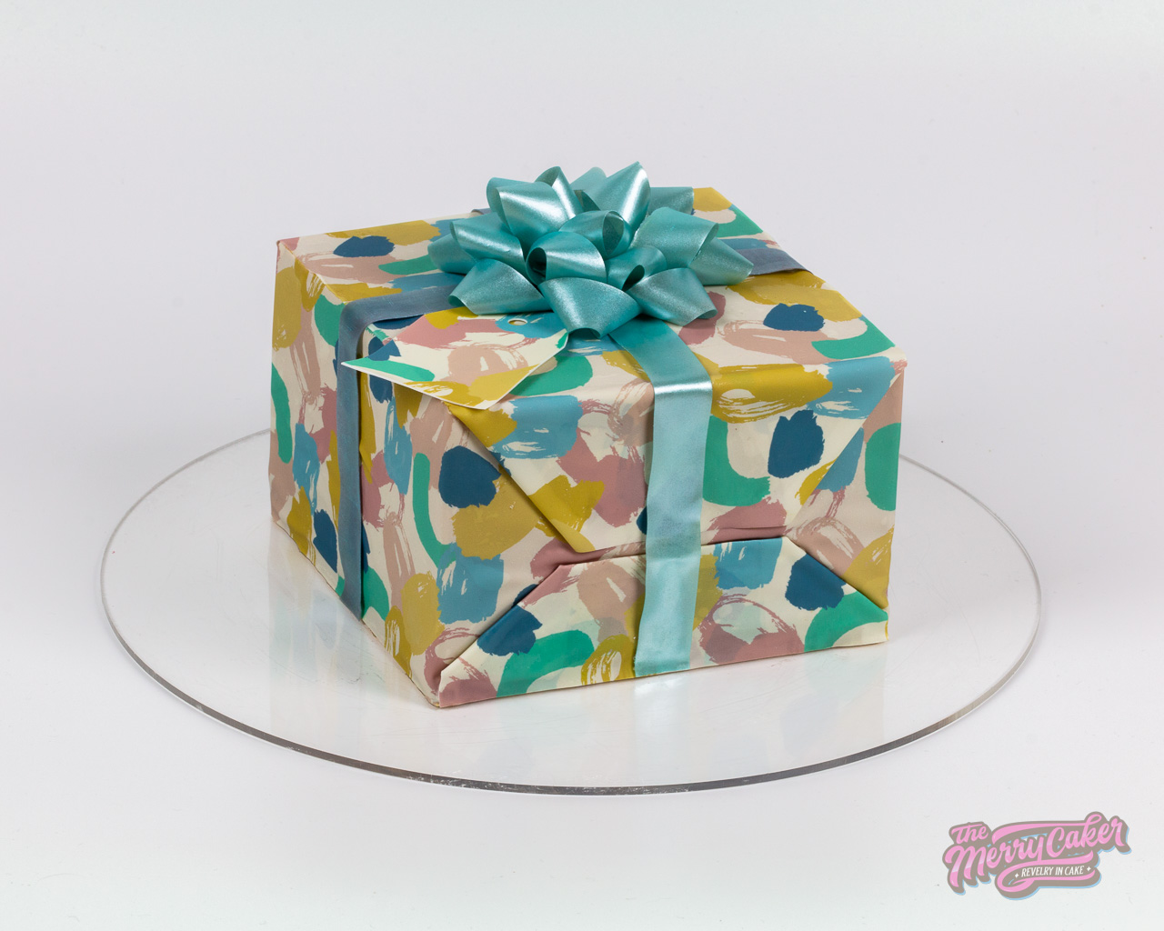 A hyper-realistic gift box present cake with an edible gift bow