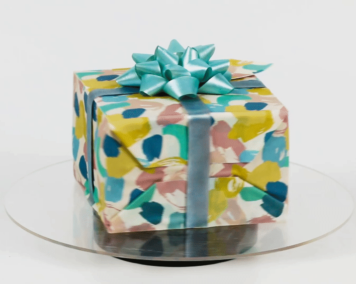 A hyper-realistic gift box present cake with an edible gift bow